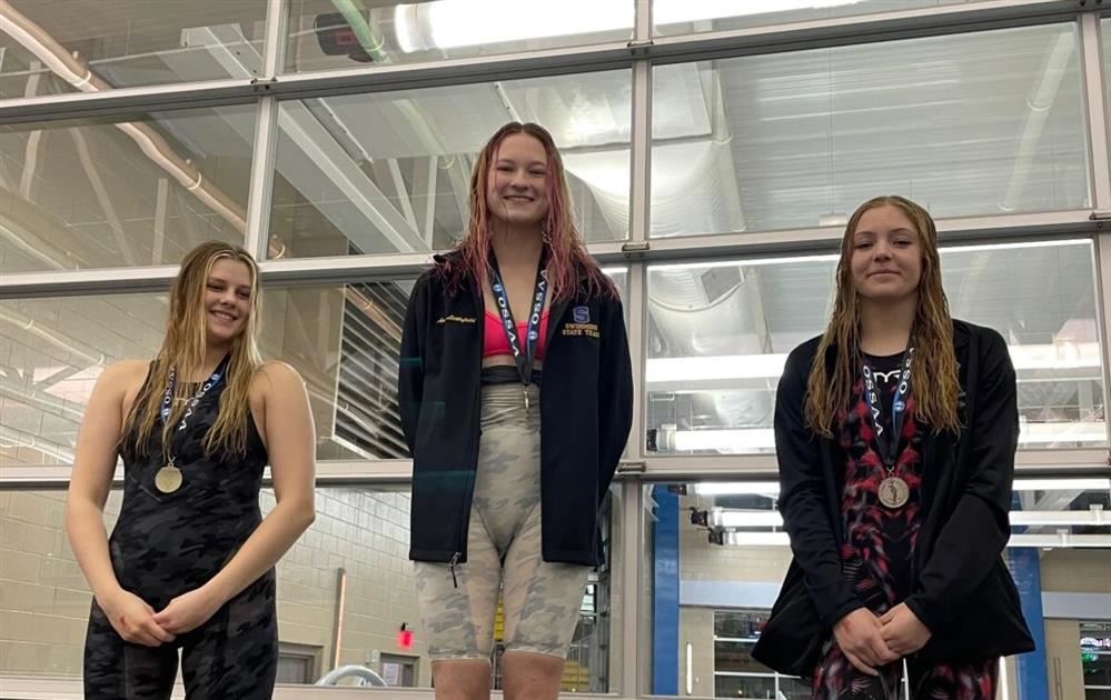  Stillwater High junior swimmer Avery Littlefield stands atop the podium after winning first place